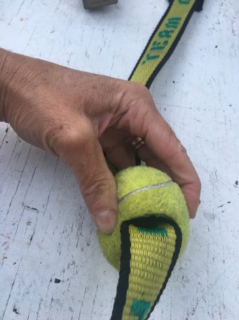 Tennis ball sliced for boat tie