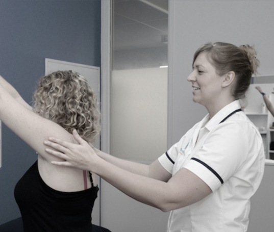 Osteopath treating a rower